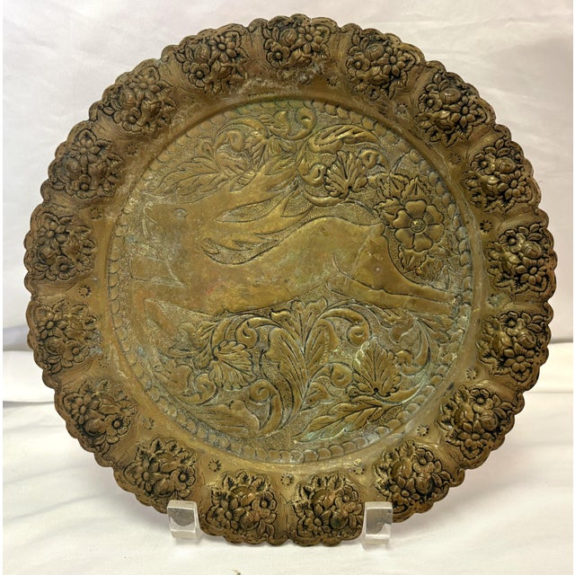 Vintage embossed brass charger plate from around the 1940's. This piece features a leaping hare surrounded by floral...