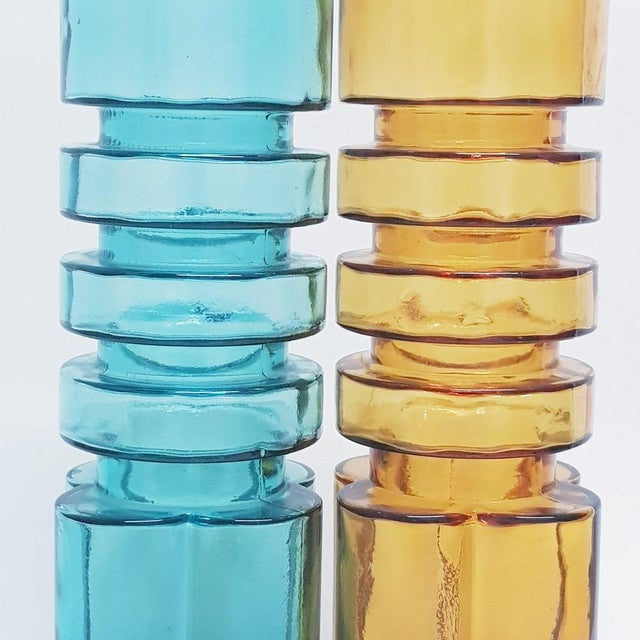 Rare Empoli abstract bottles in amber and turquoise glass with centre formed rings and flower shape. They can be used as...