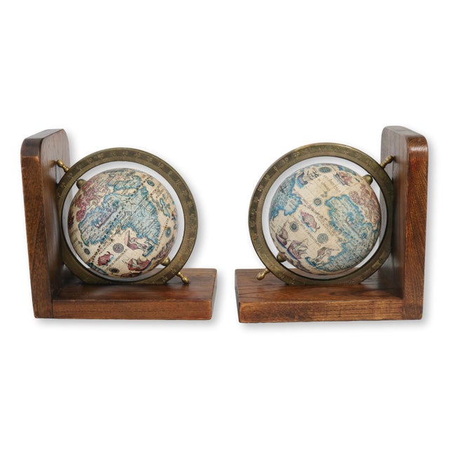 Vintage Italian globe bookends with wooden bases and brass rings. Old-world maps lend traditional charm. Light wear....