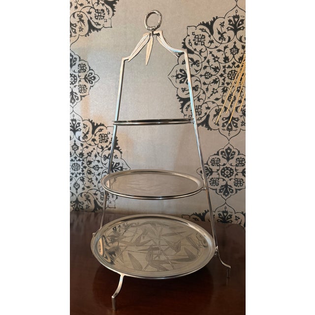 Elegant signed three-tier serving stand by Michael Aram, featuring his signature faux bamboo motif with hand-etched bamboo...
