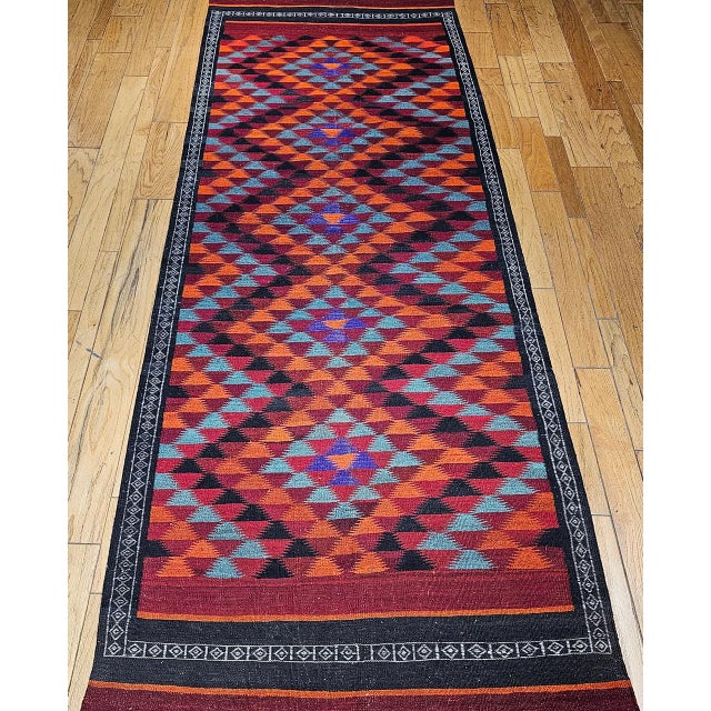 A mid-20th century Moroccan kilim of striking beauty and remarkable versatility, this wide runner features a bold...