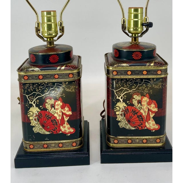 Beautiful pair of vintage tole tea caddy table lamps. Gold and red on black background . Decorated with Japanese geisha...