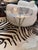 Round side table in lucite with a cinched crisscross silver finish metal base. The feet terminate with a delicate splay...