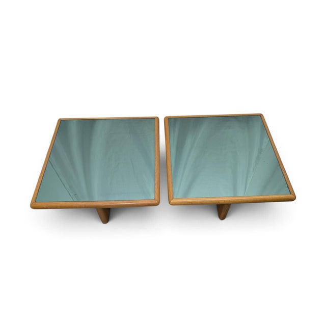 This pair of mid-century coffee tables, likely dating to the 1970s, features a solid teak frame with clean, modern lines....