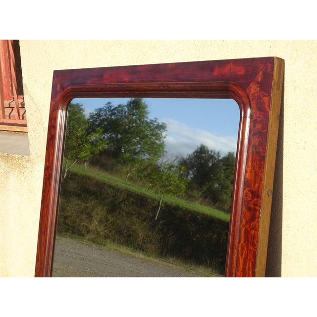Large vertical mirror in a solid wood frame with a superb flamed mahogany veneer. Natural, luminous red reflections due to...