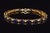 Gorgeous natural 7.09CTS diamond and blue sapphire tennis bracelet crafted in solid 18K yellow gold. This elegant bracelet...