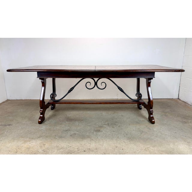 A fabulous Theodore Alexander dining table with multi-wood parquet top and medium to dark auburn brown satin finish. Metal...