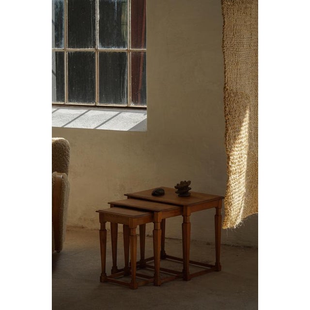 A refined set of three Danish Modern nesting tables crafted in oak, dating to the 1960s, made by a Danish cabinetmaker....