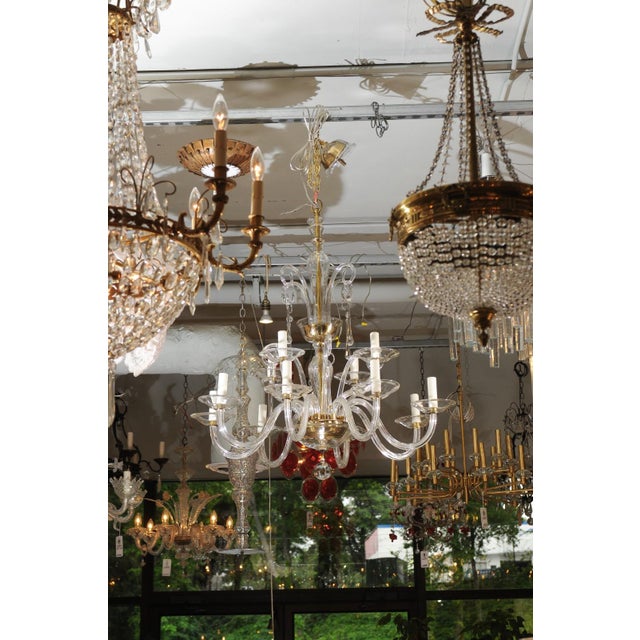 This stunning two-tier fixture has a beautiful scale while maintaining an airy feel, achieved due to the clear glass. It...