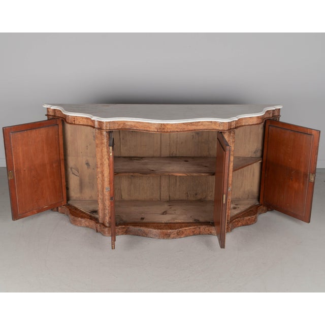A 19th century English Victorian burled of walnut, serpentine front, white marble top sideboard. Original shaped white...