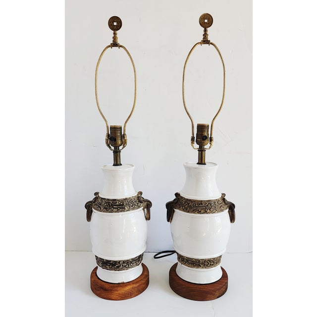 Mid-Century Hollywood Regency style Ugo Zaccagnini white pottery urn form table lamps with Far Eastern motifs. Featuring a...
