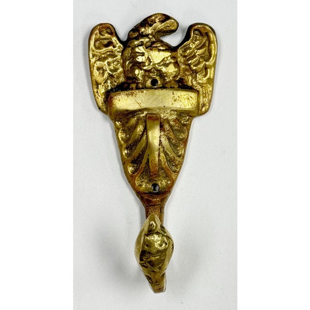 Vintage brass wall hook featuring detailed eagle motif. Patina. Holes for hanging. No hardware included.