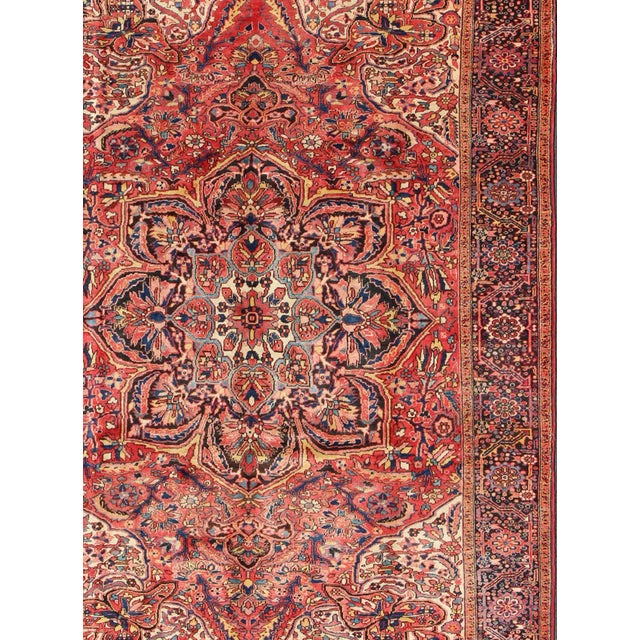 Keivan Woven Arts Heriz With Medallion Design in soft Red Tones Rug- 10′2″ × 14′. This magnificent Vintage Heriz carpet...