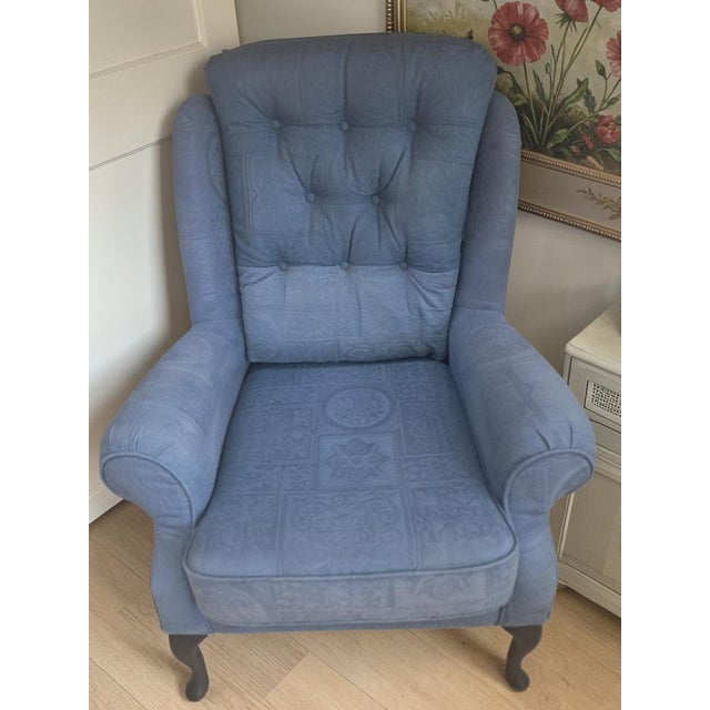 A stylish mid-century inspired wingback armchair, offering both comfort and versatility in design. Upholstered in a...