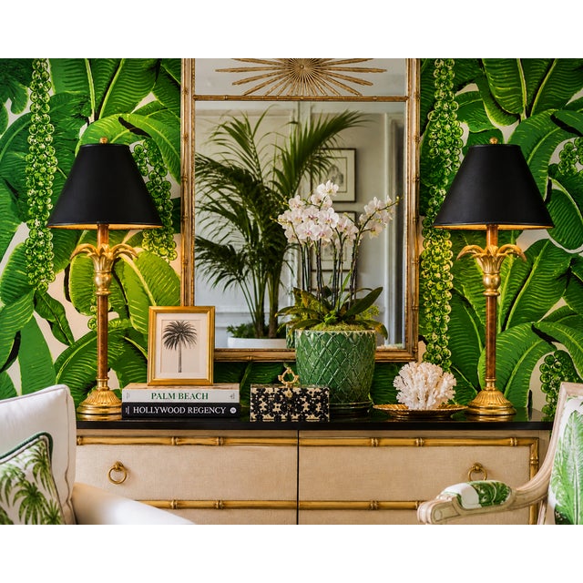 Pair of gorgeous vintage table lamps featuring a sculptural palm frond motif with a distressed gilt finish, set on a warm...
