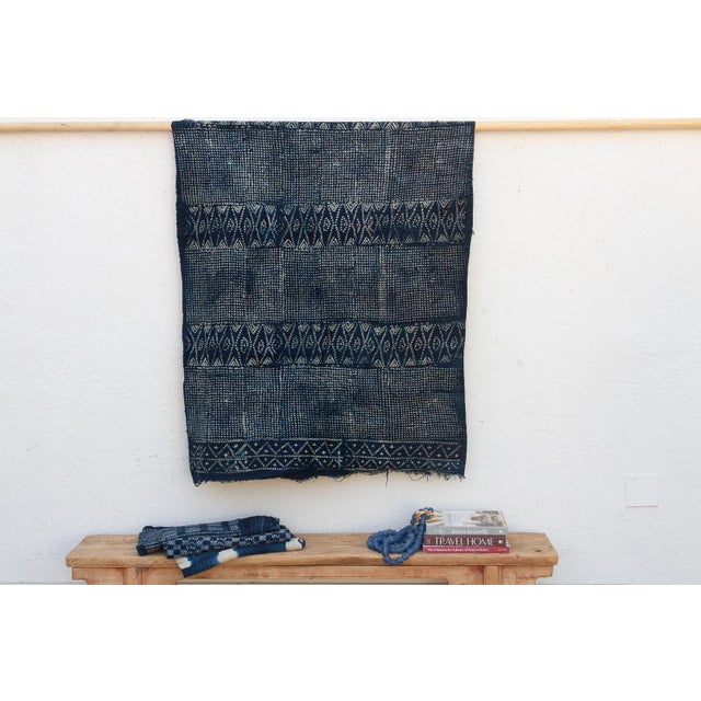 A masterwork of Malian textile heritage featuring deep indigo saturation and symbolic geometric motifs. Originating from...