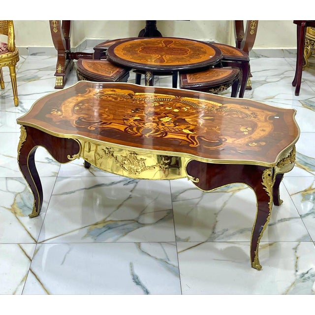This spectacular French Rococo style coffee table showcases an impressive oversized design highlighted by intricate...