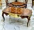 This spectacular French Rococo style coffee table showcases an impressive oversized design highlighted by intricate...