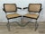 Two Cesca chairs also known as S64 with tubular steel cantilevered frame with polished chrome finish, black lacquered...