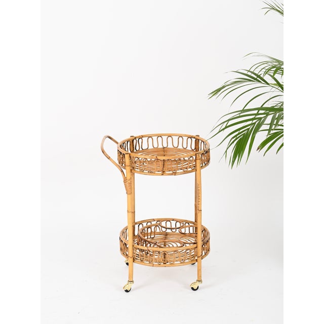Stunning Mid-Century round serving bar cart entirely made of bamboo, curved rattan and hand-woven wicker. This stunning...