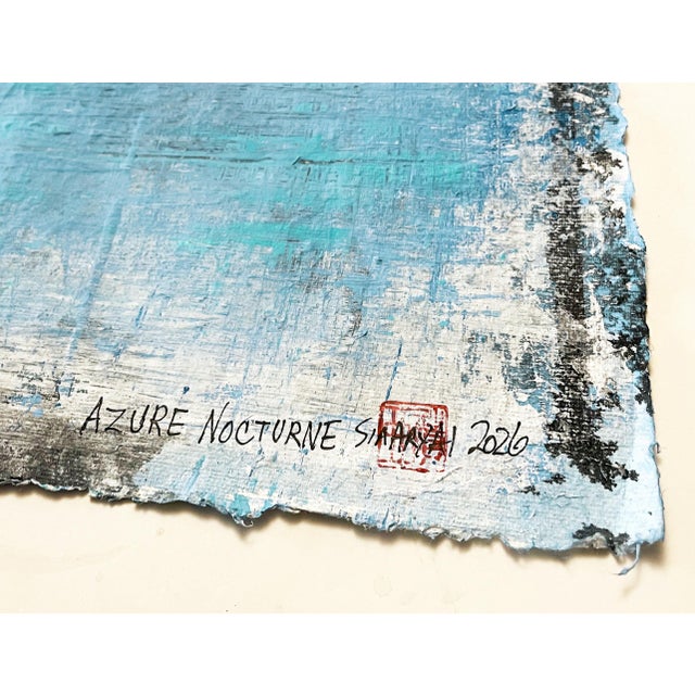 An original abstract mixed-media artwork created on handmade paper, featuring layered shades of luminous light blue and...