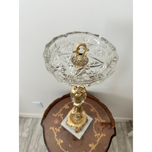 Hollywood Regency metal and glass smoke stand. Base is made of marble and all the metal has been gilded. A beautiful...