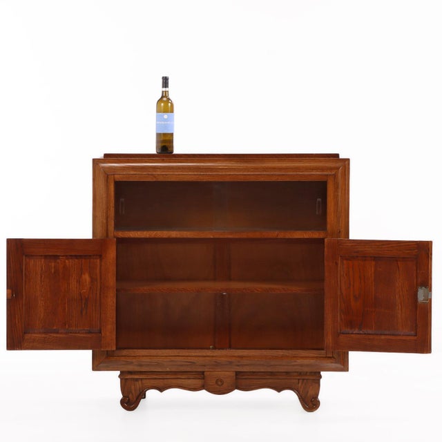 A beautifully crafted French oak server in the manner of Charles Dudouyt, featuring a rectangular case with two removable...