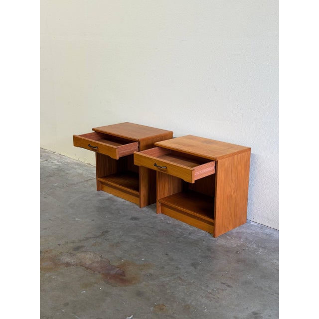 Pair of authentic Danish Mid Century Modern teak nightstands featuring clean Scandinavian lines and beautiful teak grain....