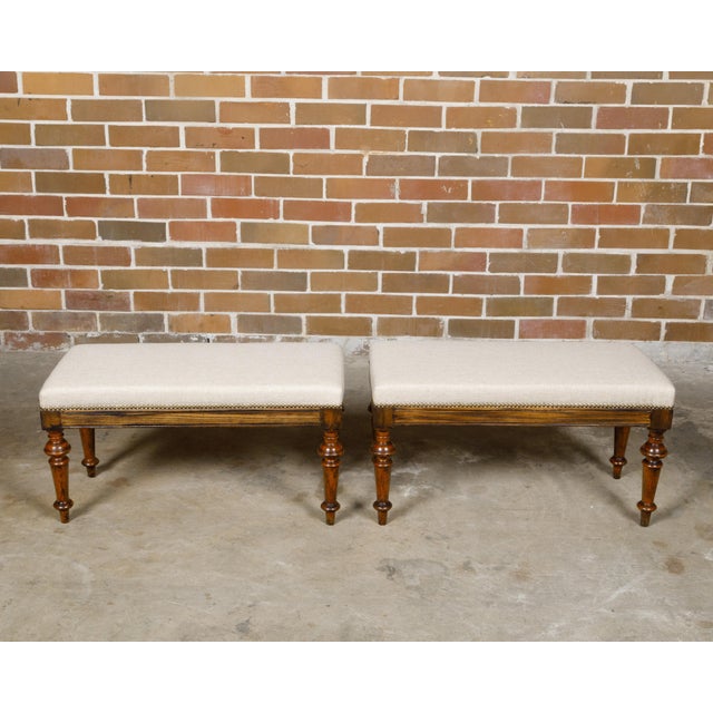 A pair of English oak rectangular stools from the 19th century with turned legs raised on arrow feet and custom...