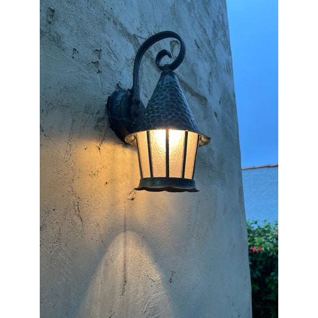 sconces are patinaed in green and charcoal, they appear to be copper metal, they have a hammered finish and have been...