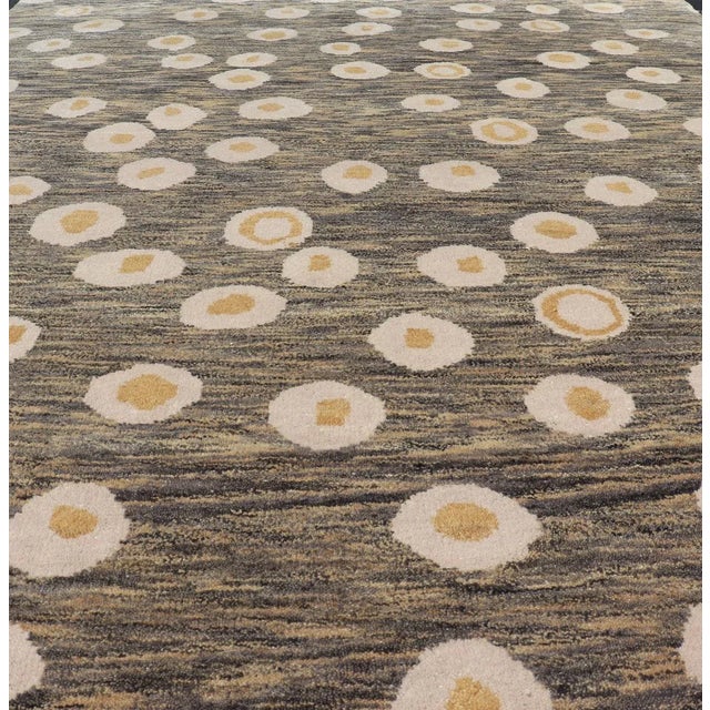 Measures 5'10 x 8'10 This piece features a blended field background, rendered in camel, green, and cocoa. The design is an...