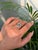 This elegant pear cut emerald and diamond Toi et Moi bypass ring is crafted in 14K white gold. The emerald measures...