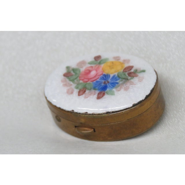 This lovely Pill Box is made of porcelain, and metal. This beautiful small pill box has white, gold, multi color flowers....