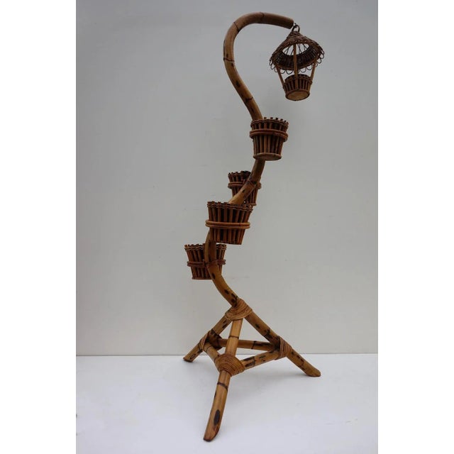This mid-century plant stand or pot holder is made of bamboo and includes the original zinc flower pots. It remains in...