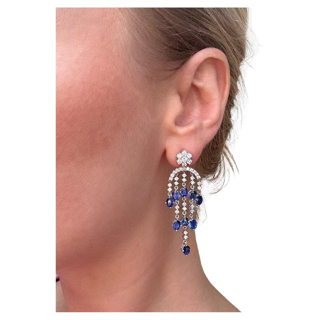 These colorful earrings feature 18 bright oval cut treated sapphires weighing approximately 5.50 carats total interspersed...