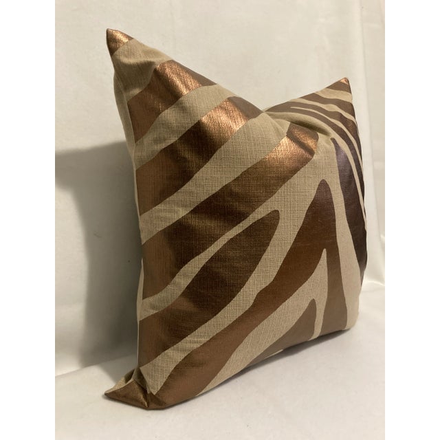 A contemporary update of an iconic animal pattern in a copper metallic foil print on a natural color linen like textured...