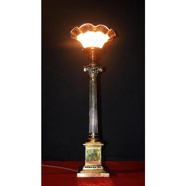 An impressive 1940s British table lamp combining classical architectural detailing with richly patinated brass and a...