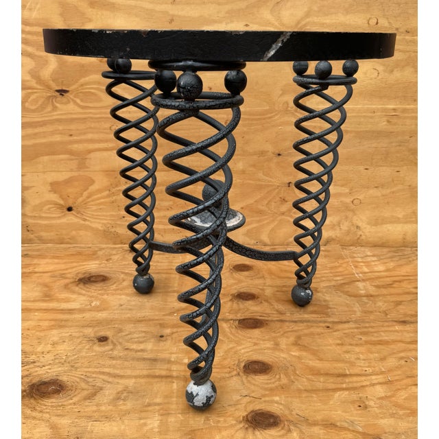 These striking side tables feature bold, sculptural spiral legs crafted from heavy steel, paired with distinctive aluminum...