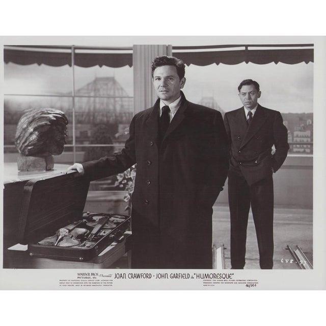 Original black-and-white lobby card for the film "Humoresque" (1946) featuring John Garfield and Oscar Levant. This...