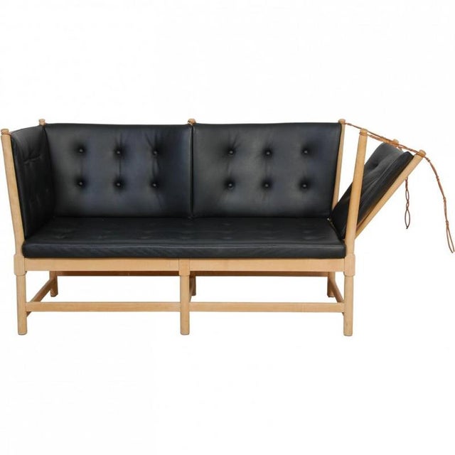 Børge Mogensen 2-seater Spoke-back sofa, model 1789, with a solid soap-treated beech frame and black leather cushions. The...