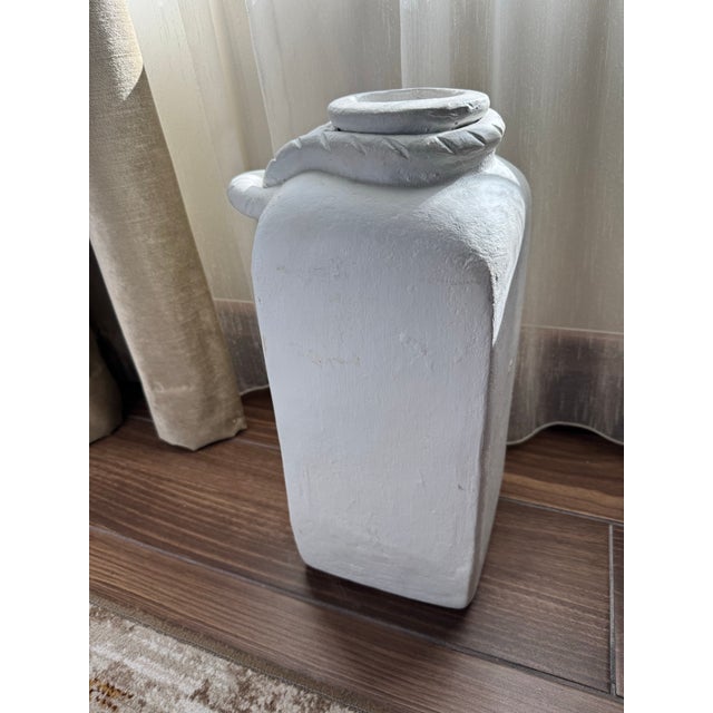 A substantial circa 1970s hand-built terra cotta planter featuring a bold architectural silhouette and expressive applied...