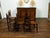 An English set of eight oak dining room side chairs from the late 19th century, with spindle motifs and wooden seats....