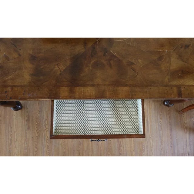 Walnut dining table with cooker in walnut root with rectangular top and turned legs. On the long side with a drawer lined...