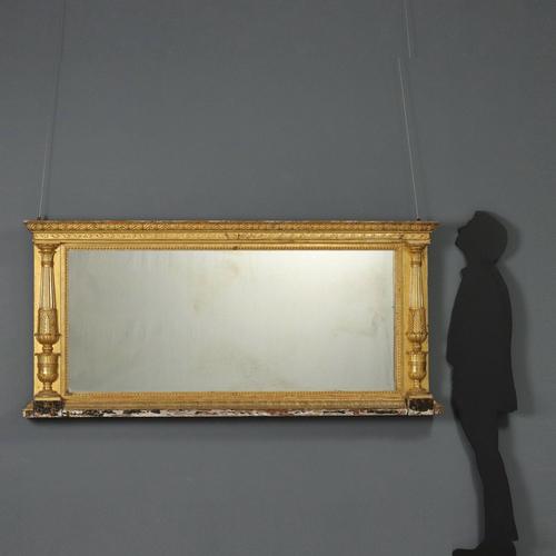 Restoration mirror in carved and gilded wood. Side uprights with turned half-columns carved with acanthus leaves and...