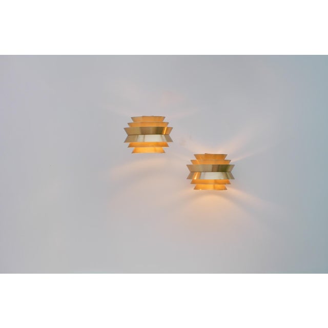 A pair of vintage wall lamps from the celebrated "trava" series, designed by carl thore for granhaga metallindustri,...