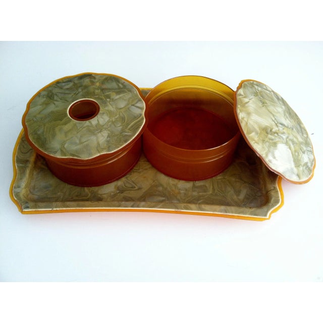 Powder your nose with this circa 1930's vanity set including a powder box, hair collector and tray. Made from resin or...