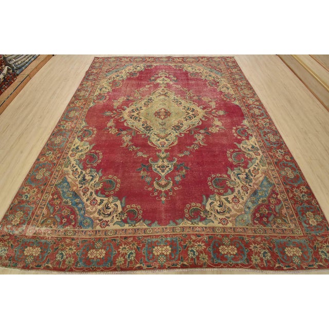 An authentic vintage traditional Tabriz rug hand-knotted with fine wool and natural dyes. This oriental rug features a...