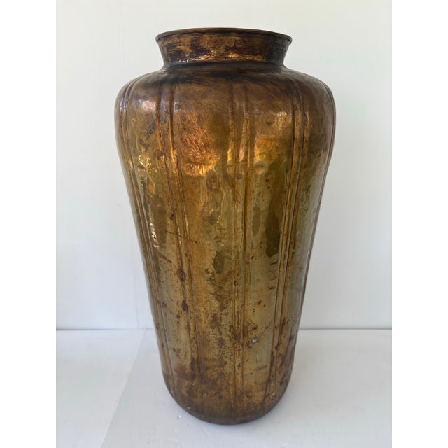 This is a striking large hand-hammered brass floor vase, measuring 16.5 inches tall and weighing 3 lbs. Made in India,...