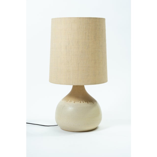 This lamp evokes the organic, nature-inspired design world of the 1970s. The handcrafted, round ceramic base features...