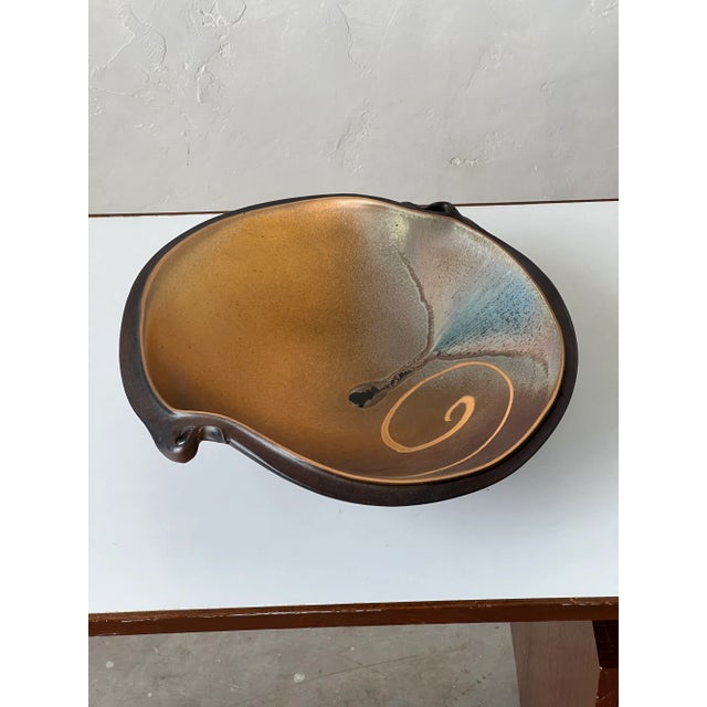Beautiful signed studio pottery bowl with fluid lines and hand pulled handles.